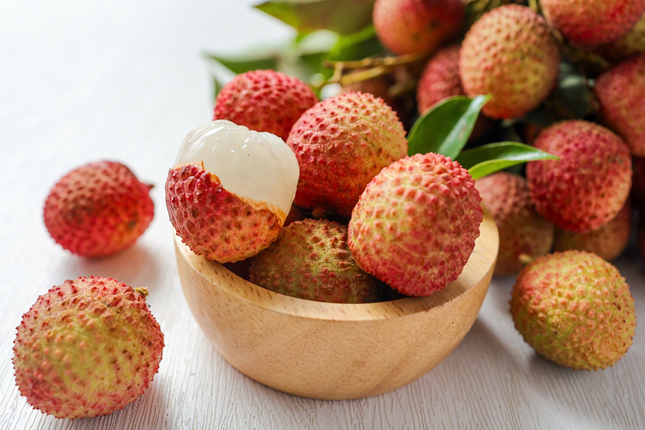 A photo showing a bowl of lychee.