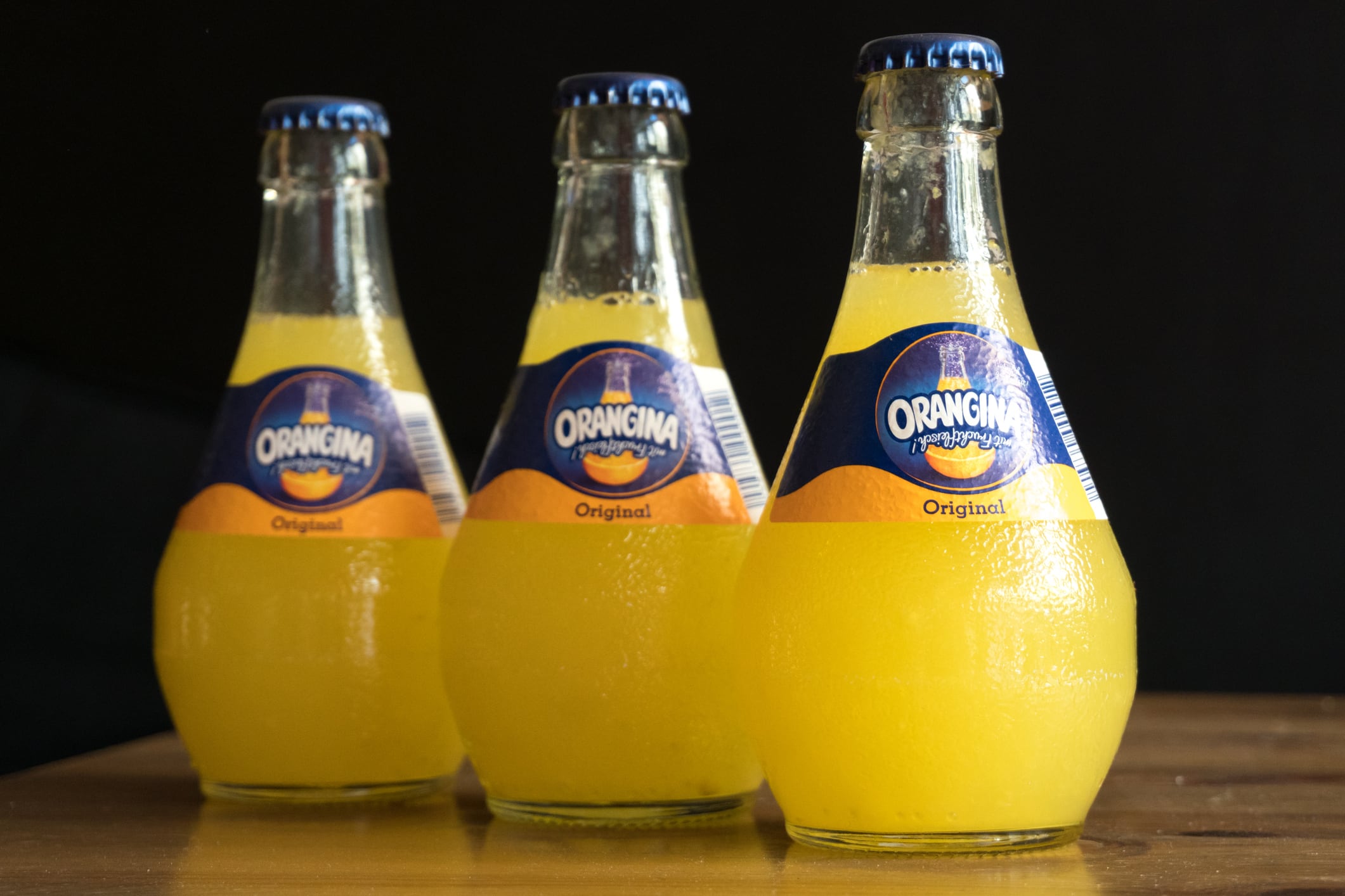 Berlin, Germany - April 22, 2016: Orangina sparkling citrus beverage with natural pulp small bulbous bottles. Orangina brand is owned by Schweppes International Limited. The name itself is indicative of the fruit, sunshine, color and Mediterranean origins behind the success of this unique French soft drink