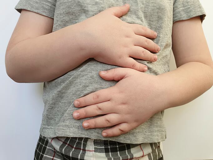 A picture showing a boy with stomach ache.
